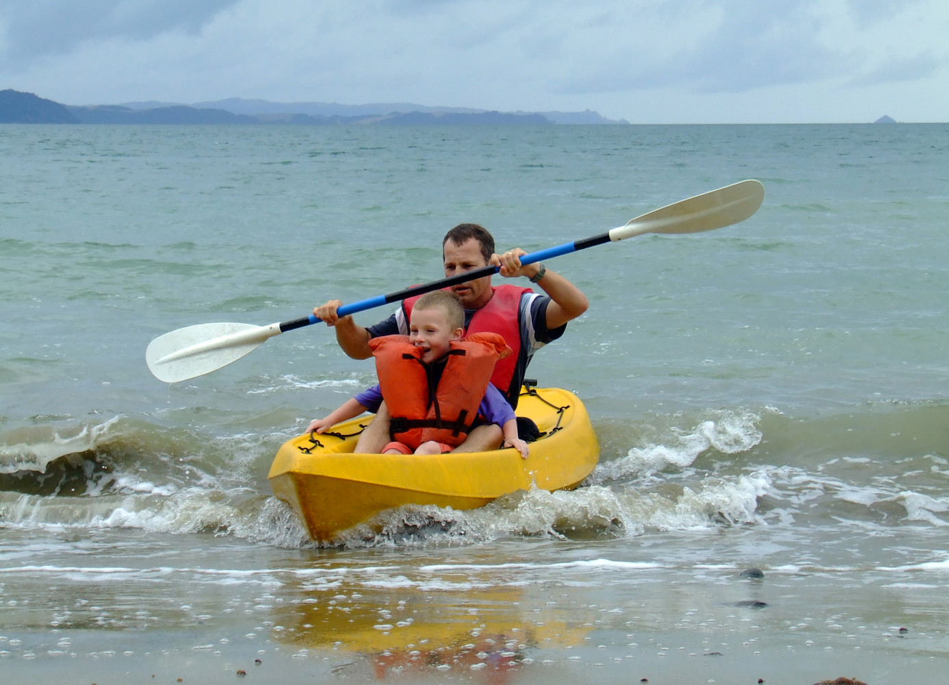Man with boy in kayak