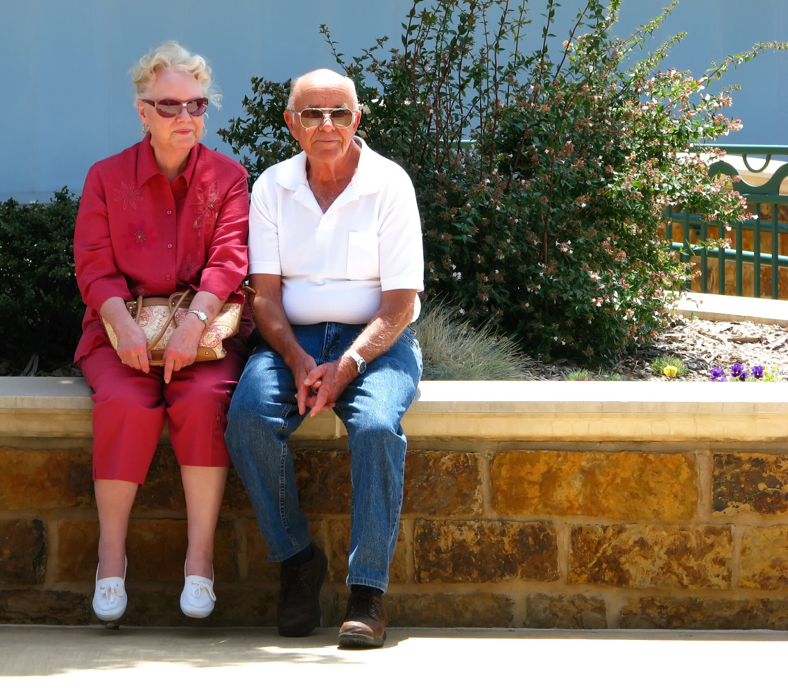 Photo of elderly couple sitting outside