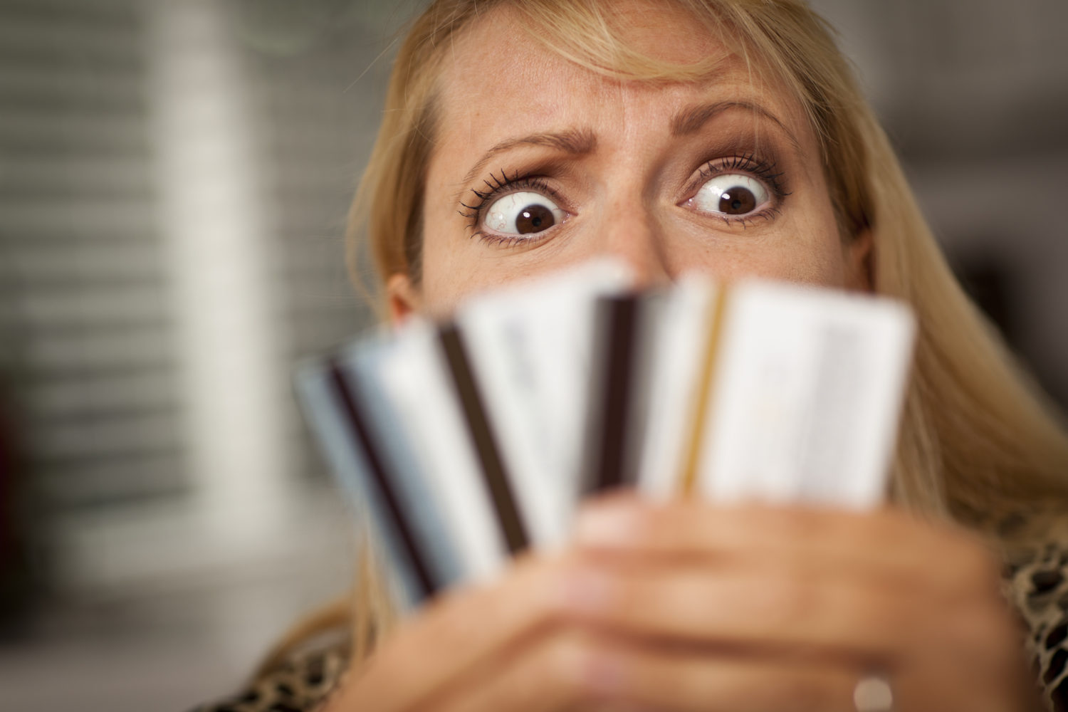 Woman Glaring At Her Many Credit Cards.